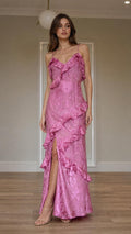 Front view of model wearing pink ruffled slip maxi dress with slit