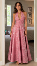 Front view of model wearing the pink floral jacquard halter maxi dress