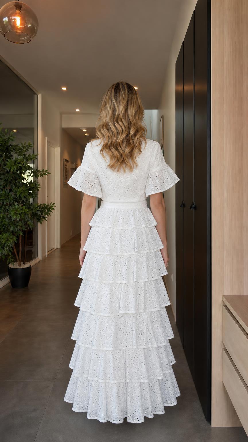Back view of model wearing white eyelet two-piece maxi skirt set