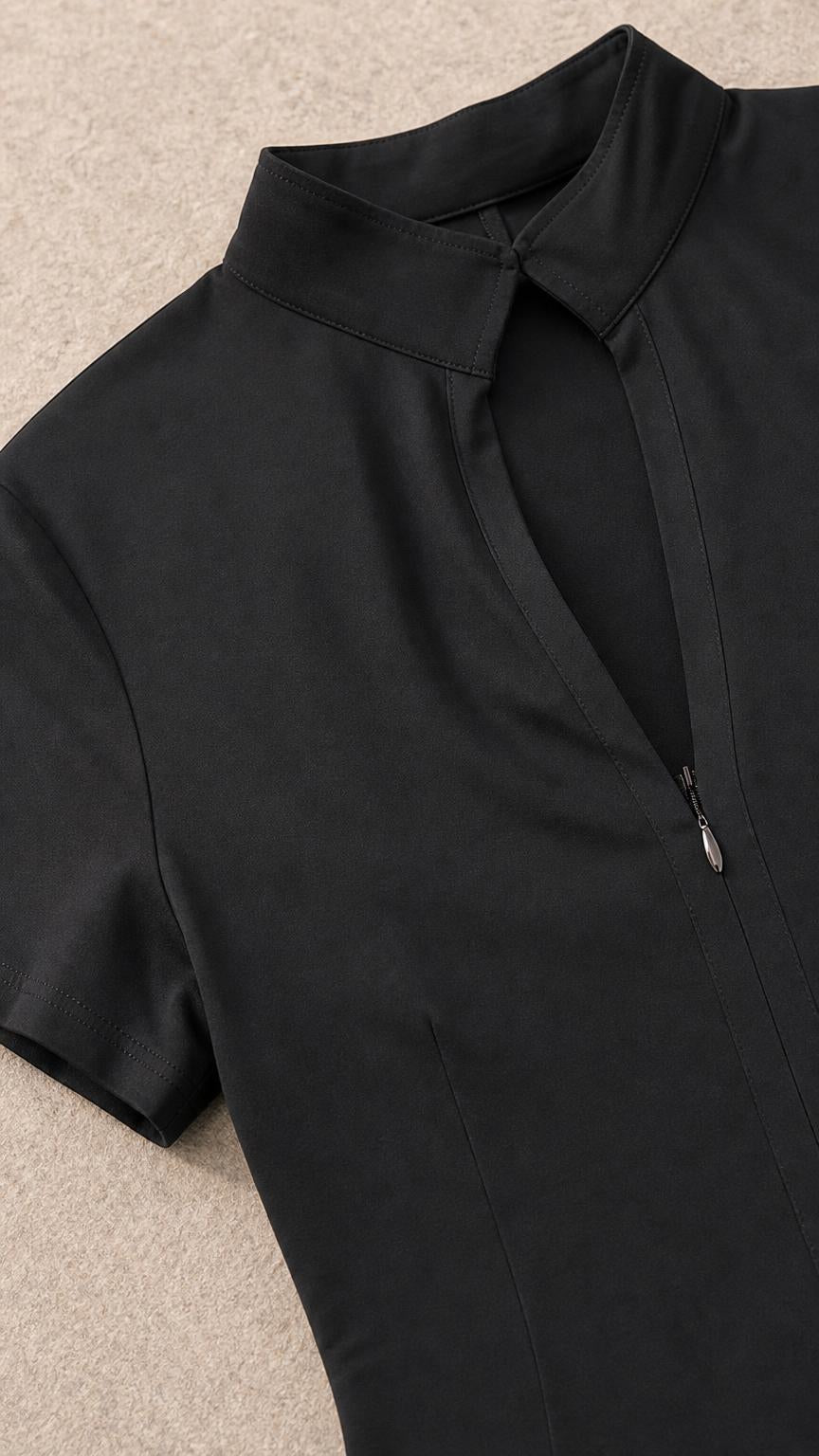 Close up detail of mock neck and zipper on black dress
