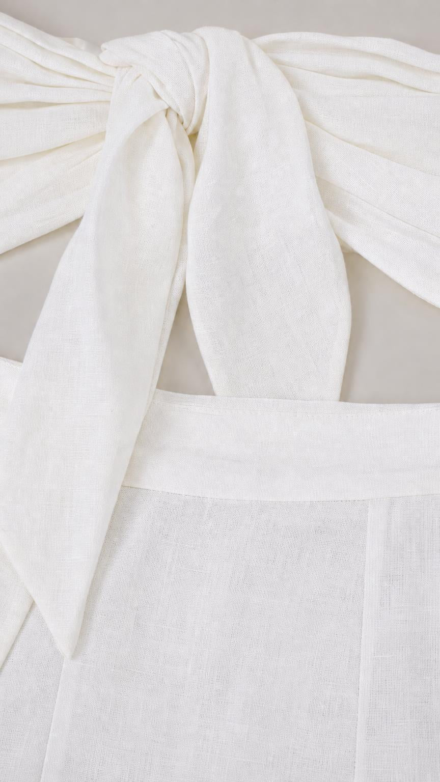 Close-up of fabric texture and front knot detail on white top